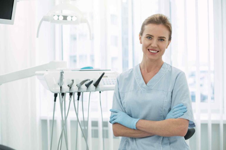 A woman standing in front of some dental equipment.
