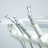 A row of dental instruments sitting on top of each other.