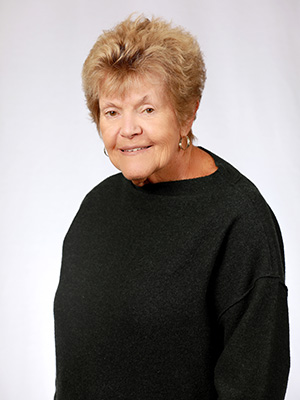 A woman in black shirt smiling for the camera.